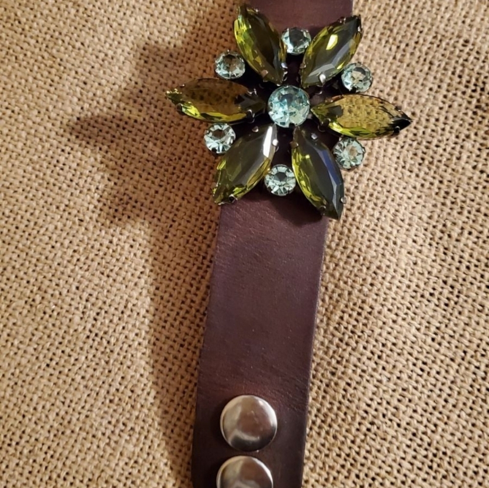Leather cuff bracelet embellished with a vintage brooch.